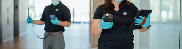 Two UL insprectors in masks conducting indoor air quality testing